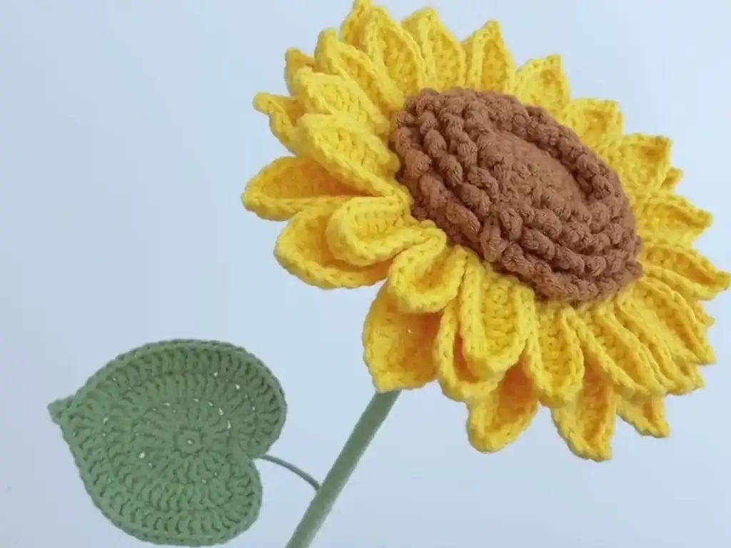 Finished crochet sunflower showcasing detailed petals and center.