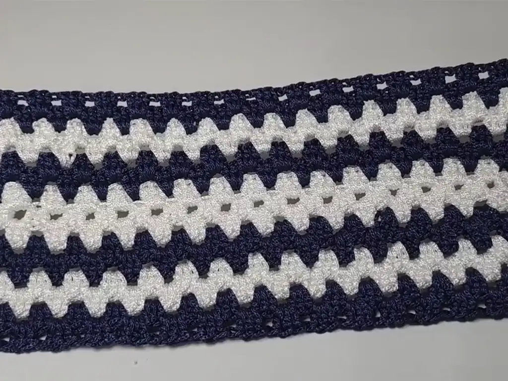 Close-up of a crochet macrame beach tote bag base, showing the double crochet stitches and corner spaces