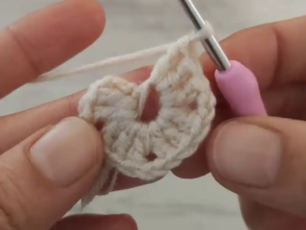 Close-up view of the stitch detail in crochet baby booties.