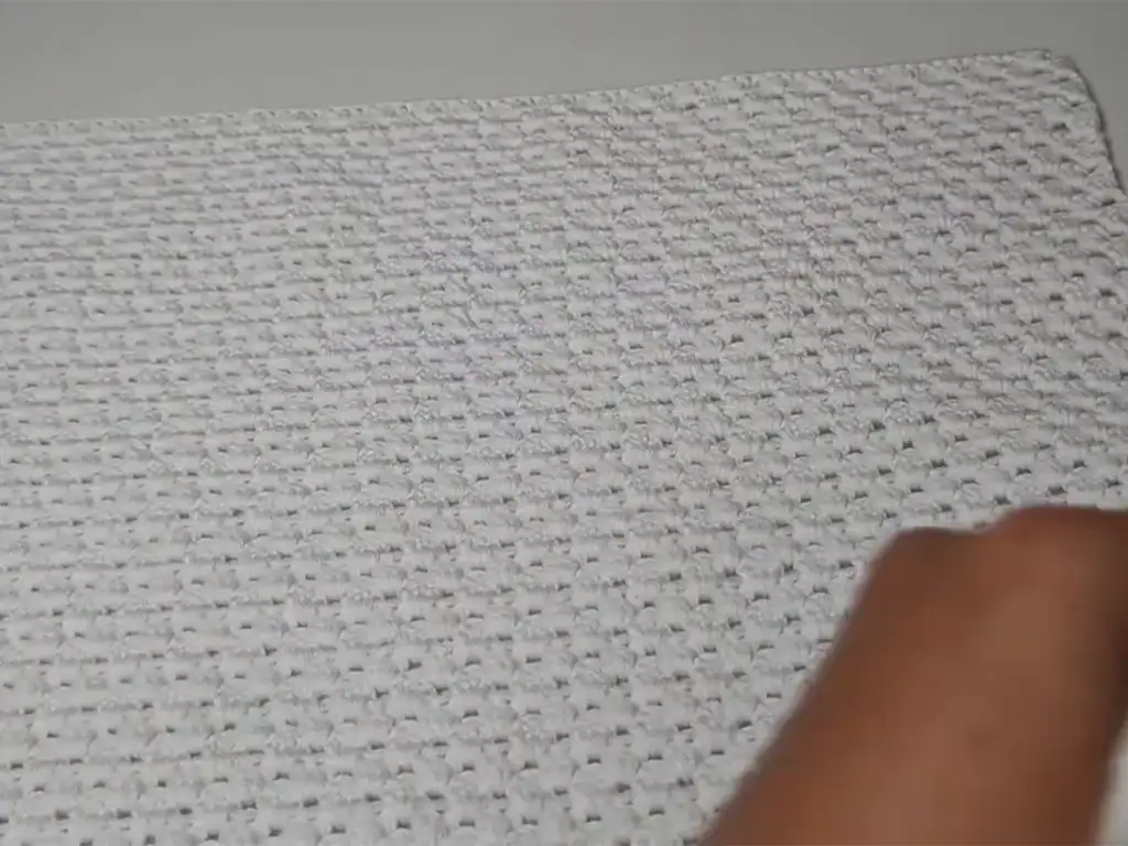 A photo of the crochet crop top back panel being worked, highlighting the consistent stitch pattern for a smooth finish.