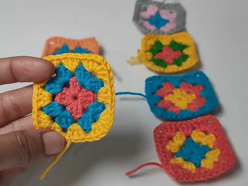 Close-up of colorful granny squares used in a crochet crop top pattern.