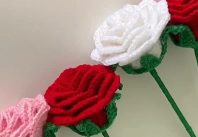 A close-up view of a crocheted rose bouquet, highlighting the beautiful colors, textures, and details of the crochet roses.