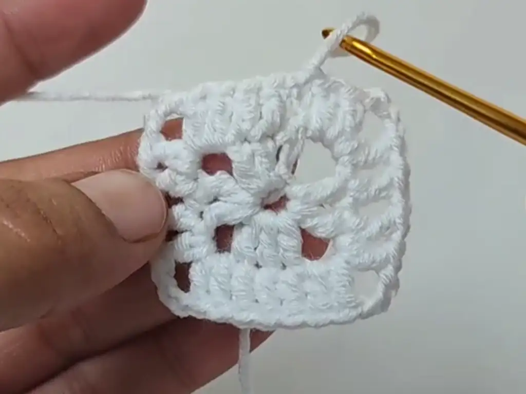 Continue working rounds, following the pattern to expand your crochet square.