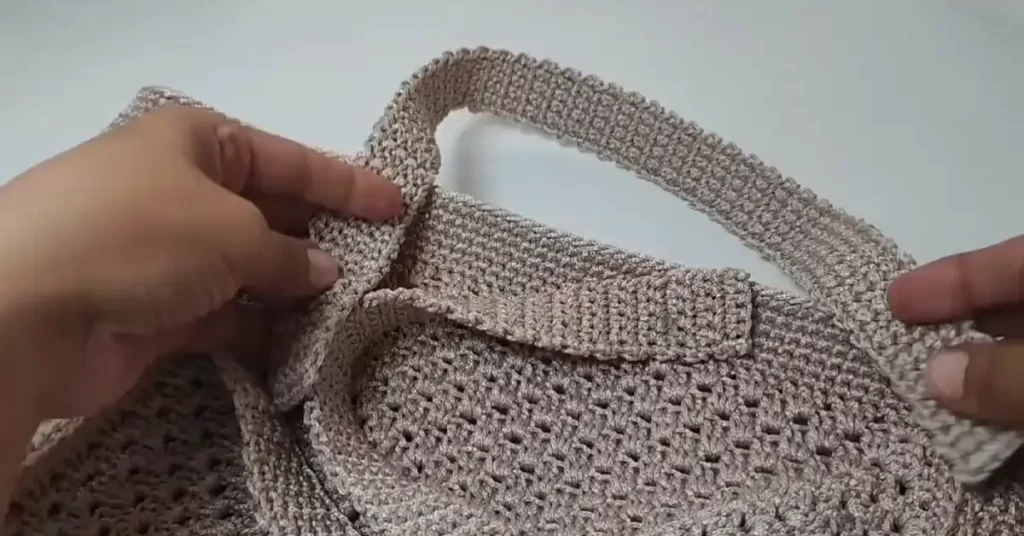 Adding handles to the crochet tote bag with single crochet stitches.