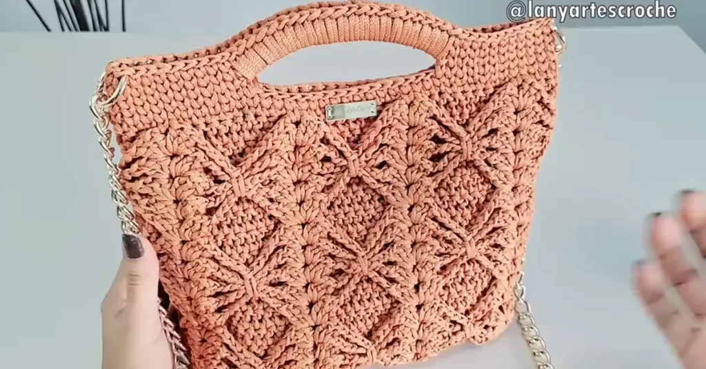 The finished crochet bag, showcasing the diamond stitch pattern and chain strap.