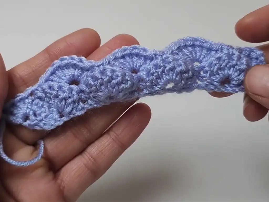 A close-up of the first row of the crochet baby blanket pattern, showcasing the initial stitches and textured design.