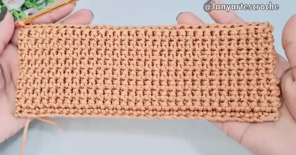 The completed base of the crochet bag, worked in a textured stitch pattern.