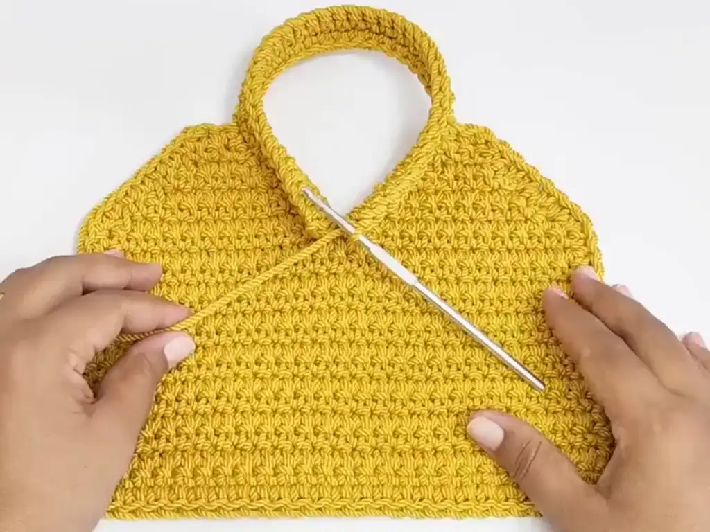 Attaching the handle to a crochet bag pattern.