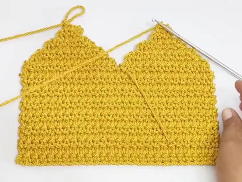 Decreasing stitches on the sides of a crochet bag pattern.