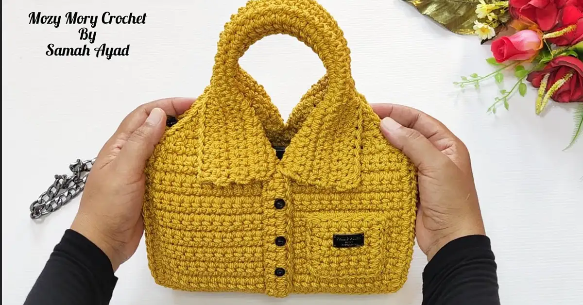 A crocheter proudly displays the finished crochet bag, showcasing its vibrant color and professional finish.