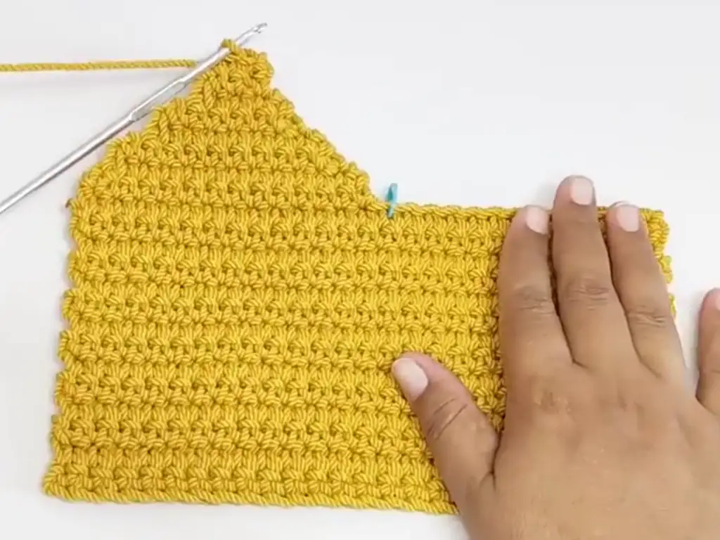 Crocheting the first row of the bag's sides.
