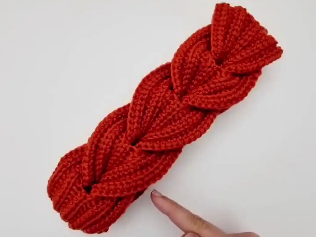 The completed crocheted headband with a beautiful braided pattern.