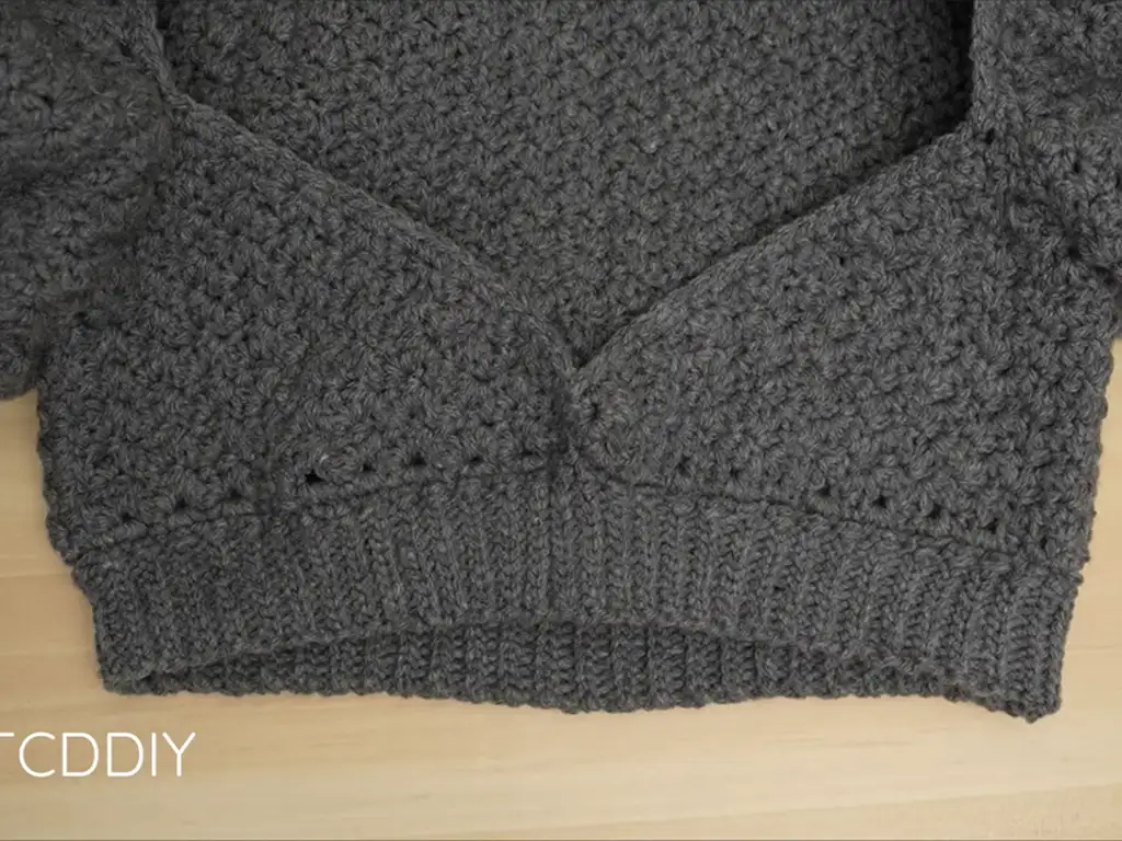 Adding a neat finish: The completed bottom band of the crochet puff sleeve crop top.
