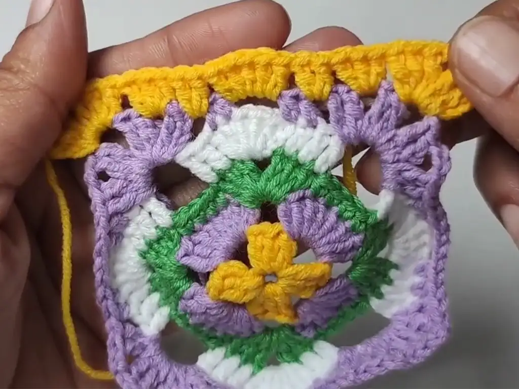 A close-up view of the textured border on a completed crochet granny square.