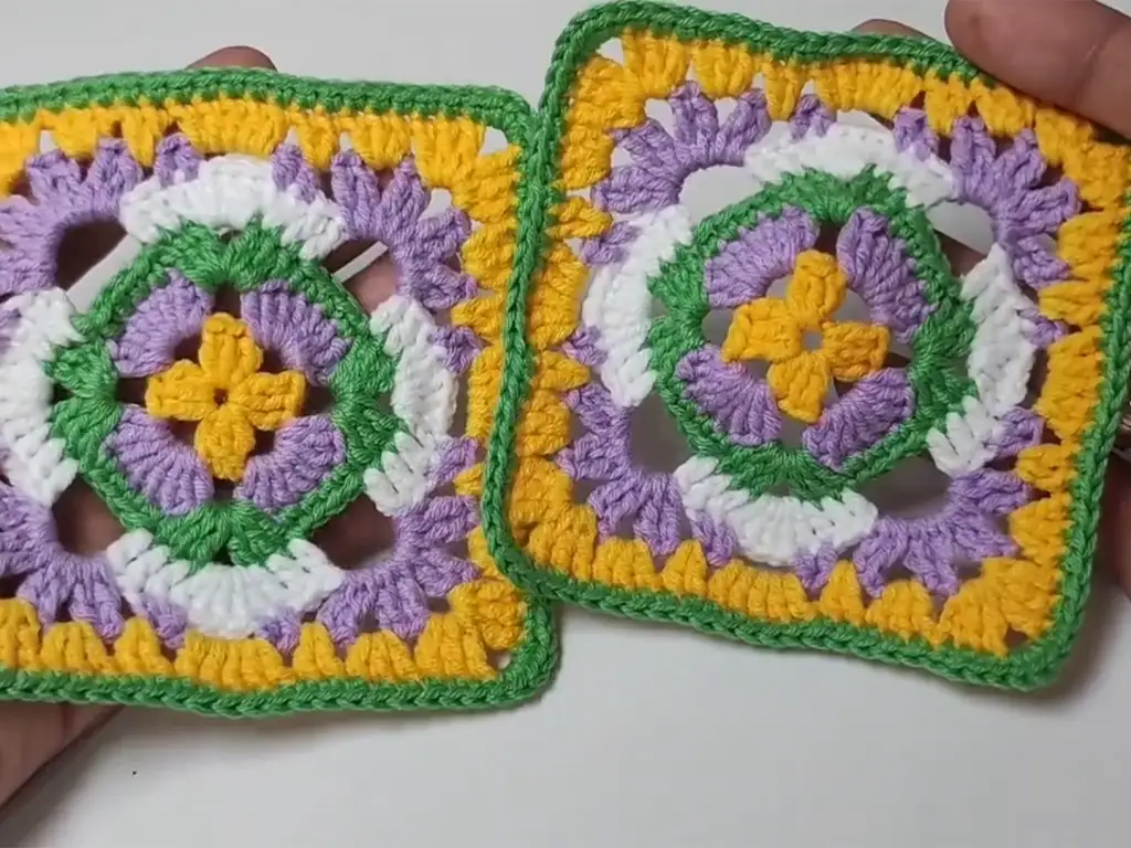 Two finished crochet granny squares side by side, showcasing the beautiful color variations possible with this pattern.
