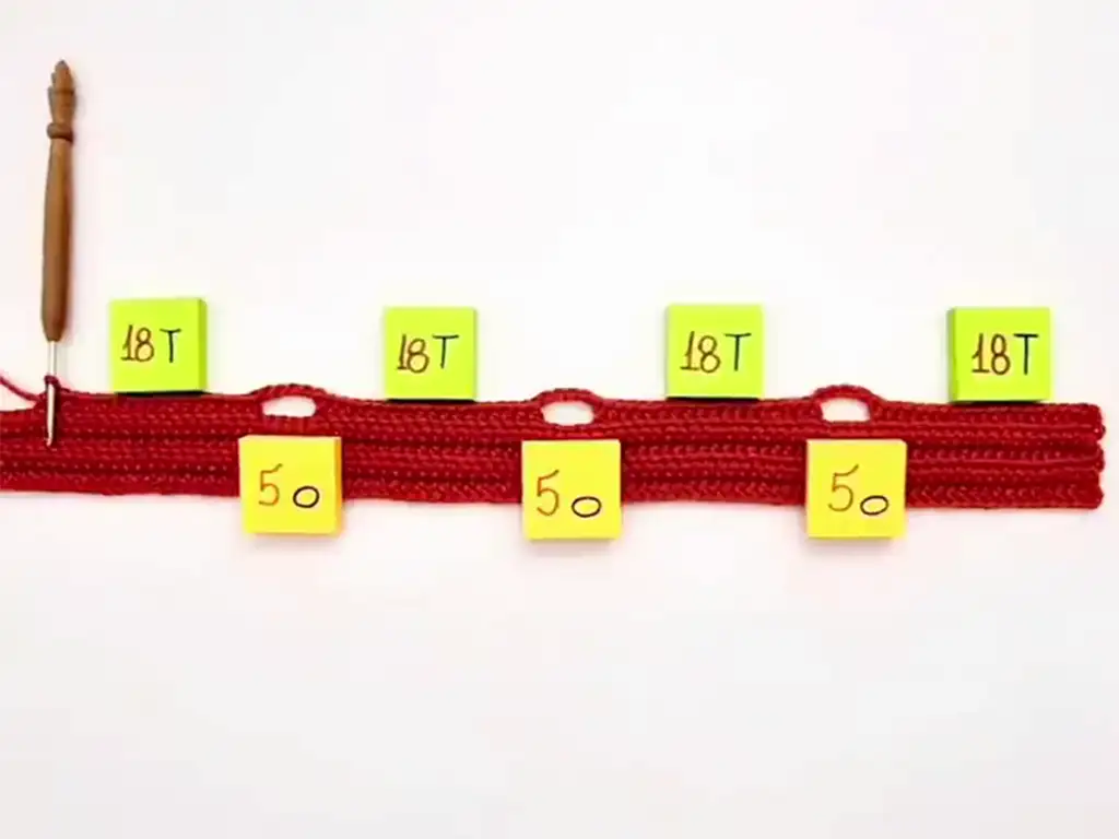 Crocheted strip with notes showing the stitch counts for each section.