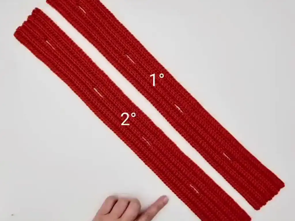 Two completed crochet strips ready to be braided together for the headband.