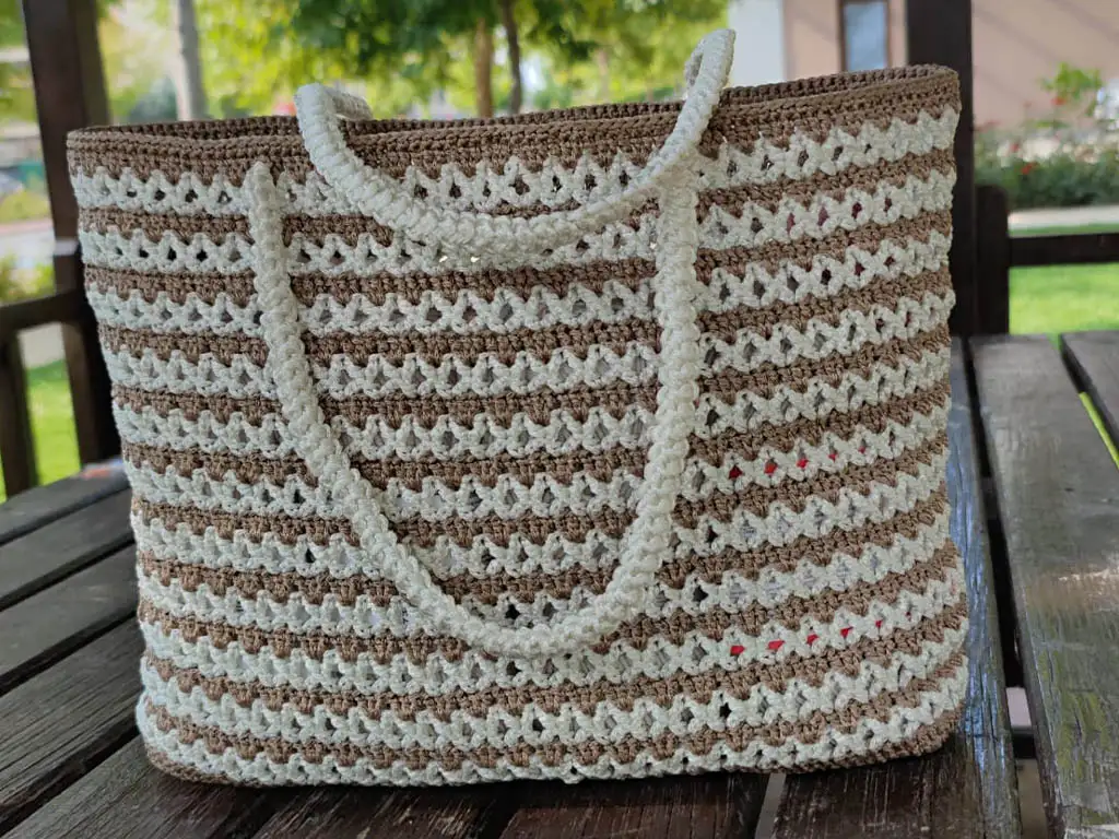 A close-up view of a finished crochet macrame tote bag, showcasing the intricate details.