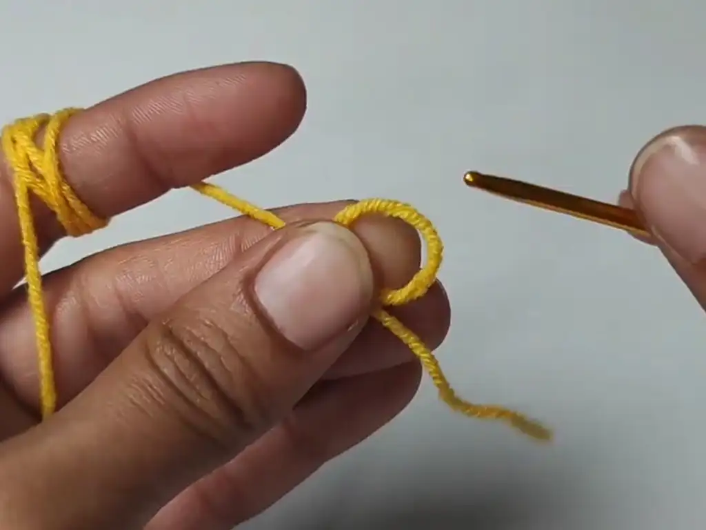 Step-by-step guide on how to create a magic ring, the foundation for many crochet projects like granny squares.