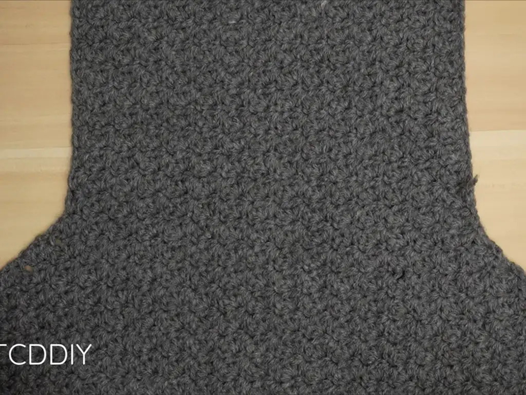 The back panel of the crochet puff sleeve crop top, worked in the same stitch pattern.