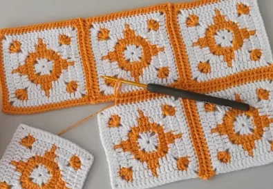 Multiple rows of crochet squares are seamlessly joined together, showcasing a growing project using the tutorial's technique.