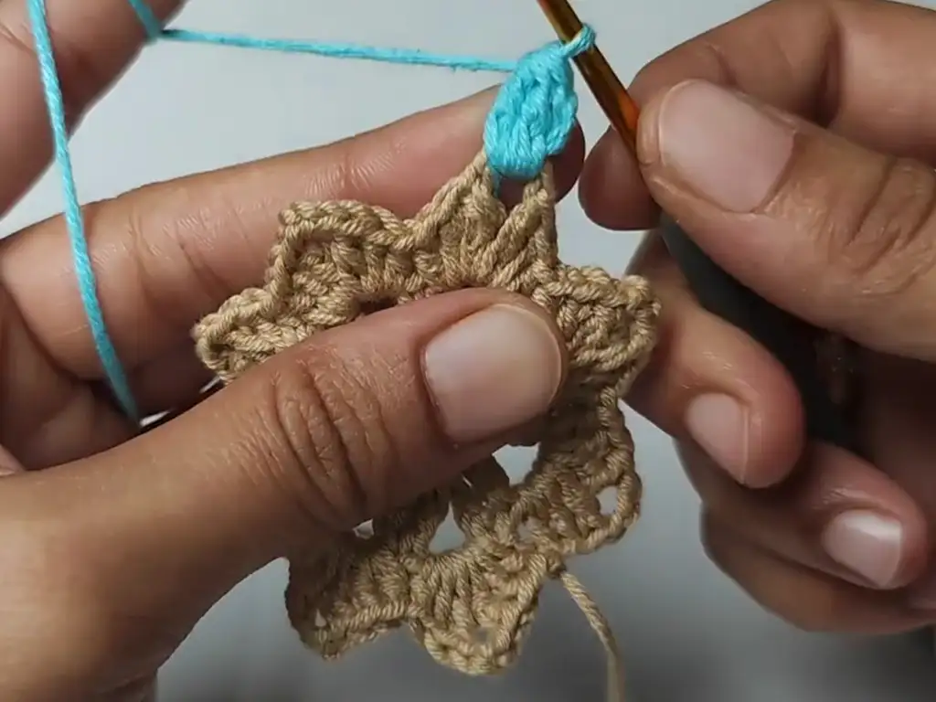 Introducing a new color (blue) to the crochet square pattern.