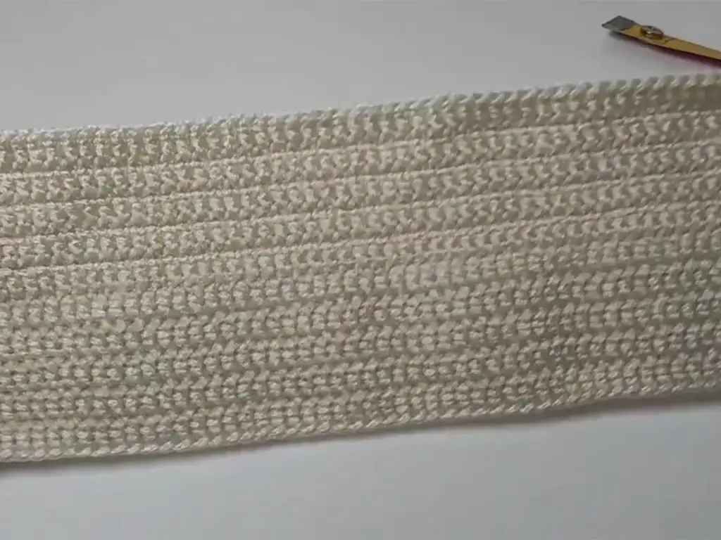 The completed rectangular base of the crochet tote bag, made with cream macrame yarn.