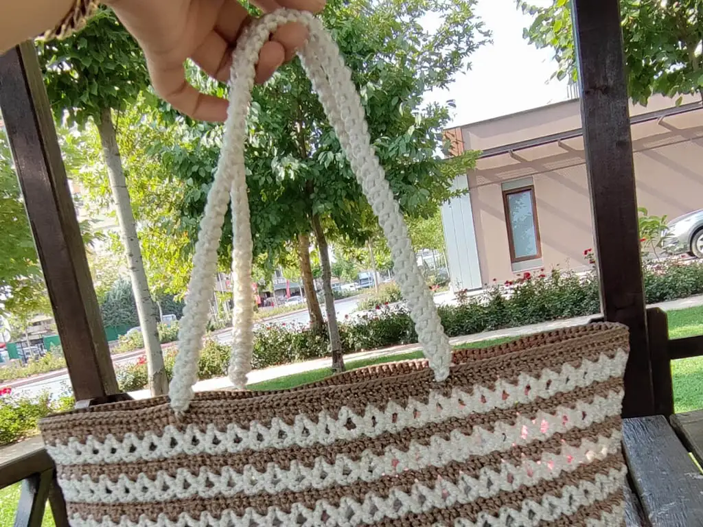 The crochet tote bag with its sturdy macrame rope handles, ready to be used.