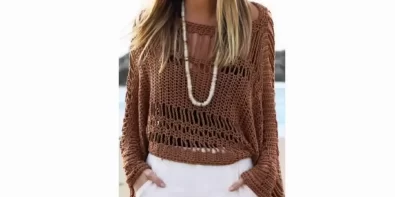 Stylish woman wearing a brown crochet tunic with a boat neckline and open sides, perfect for summer.