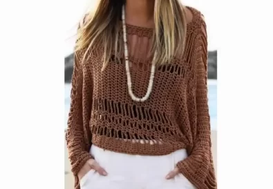 Stylish woman wearing a brown crochet tunic with a boat neckline and open sides, perfect for summer.