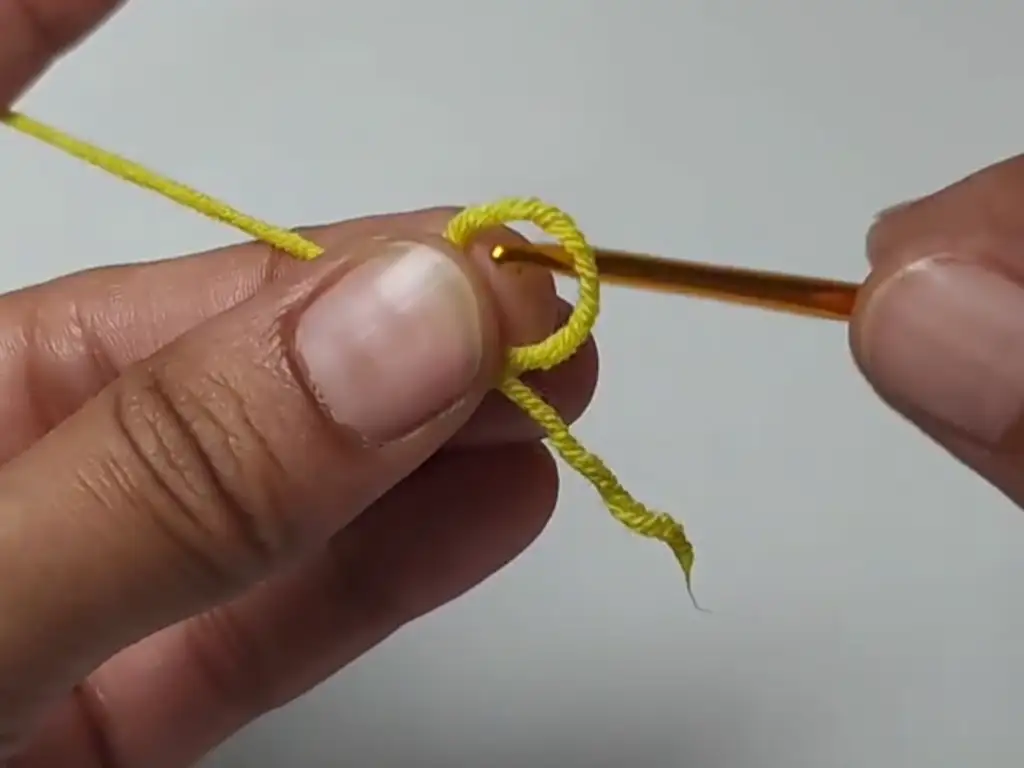 Crocheting a magic ring, a common starting technique for crochet projects.
