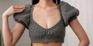 Stylish grey crochet crop top with puff sleeves, perfect for summer.