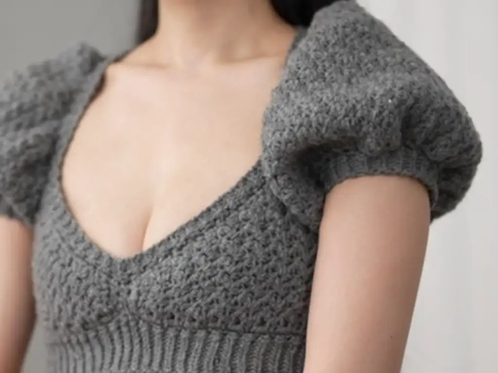 Side view of the puff sleeve crop top, showing the fit and the voluminous sleeves.
