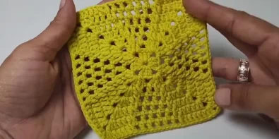 Crocheted square with intricate geometric design.