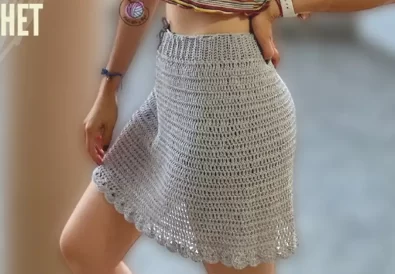 Gray crochet A-line skirt with a scalloped edge, modeled on a person.