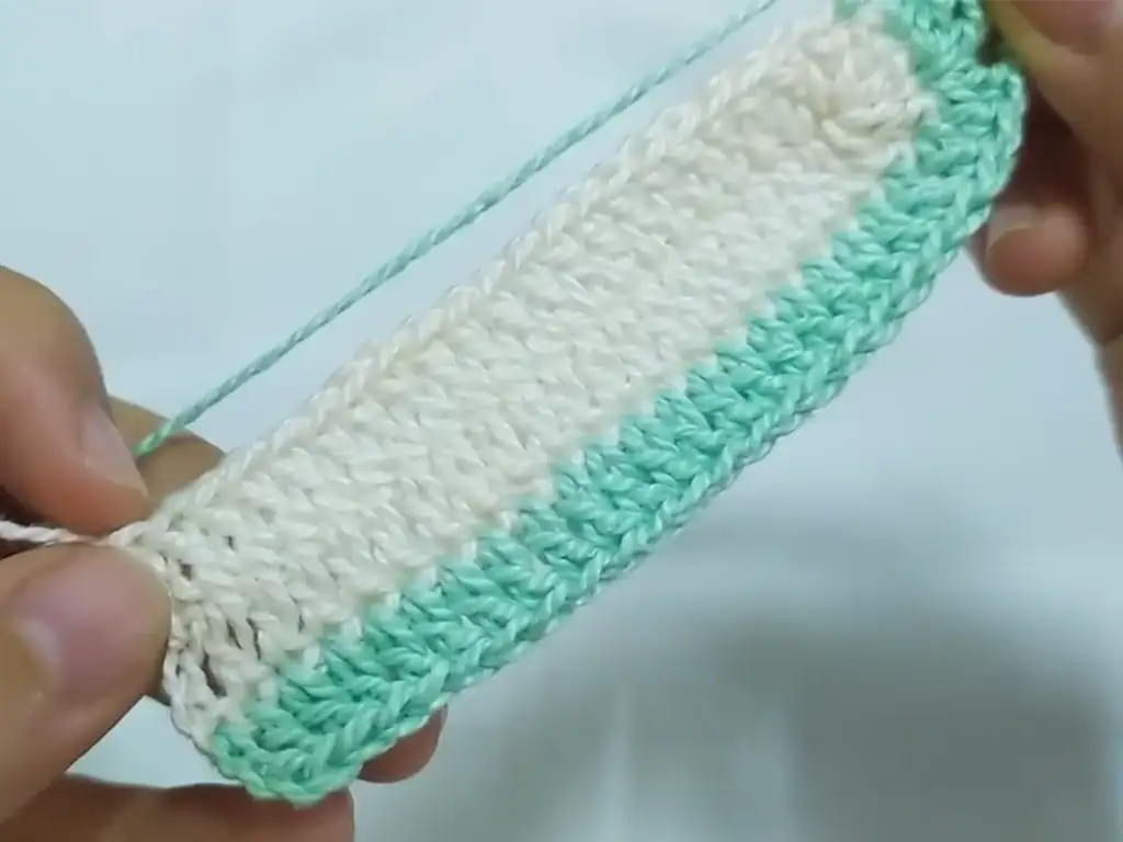 Crocheting a color change in a project, creating an ombre effect.