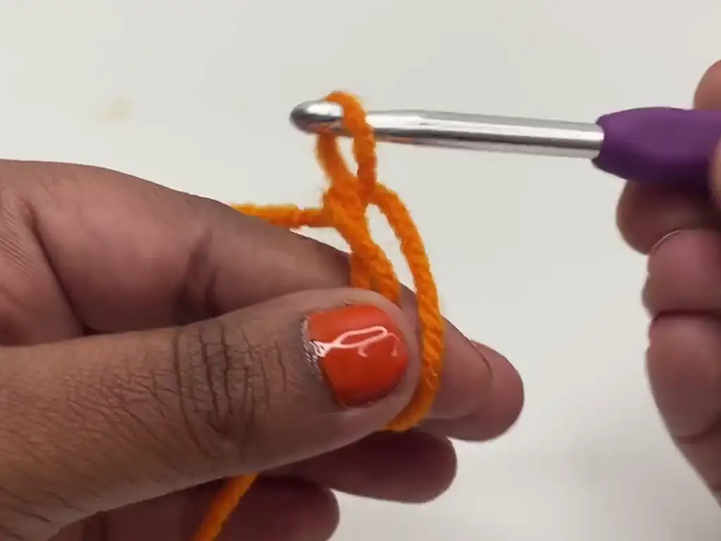 Step-by-step guide on how to make a magic circle for the crochet pumpkin.