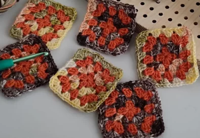 A collection of colorful crochet square motifs in various color combinations.