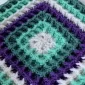 Colorful waffle stitch granny square on a white background.