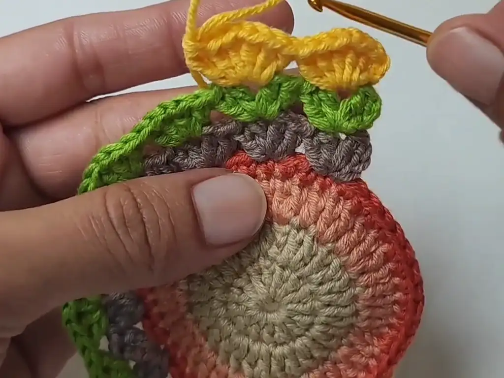 rocheting the feather rounds of the turkey coaster, adding texture and color.