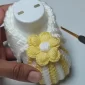 Finished crochet baby bootie with a flower embellishment.