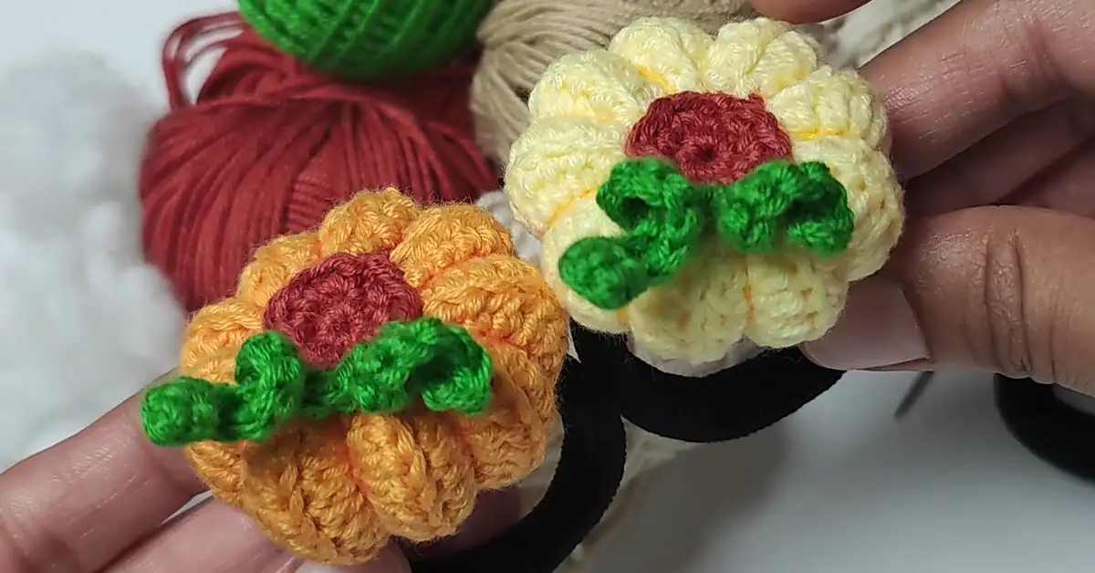 Two handmade crochet pumpkin hair ties, perfect for fall.