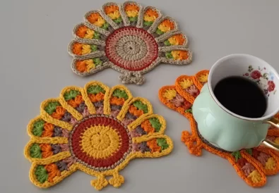 completed crochet turkey coasters, showcasing variations in color choices.