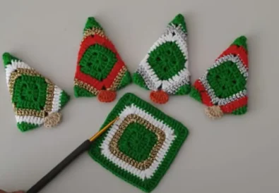 Finished crochet Christmas trees and a flat square motif with a crochet hook, demonstrating the project stages.