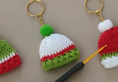 Festive crocheted Santa hat keychains in red, white, and green. Perfect Christmas gifts!