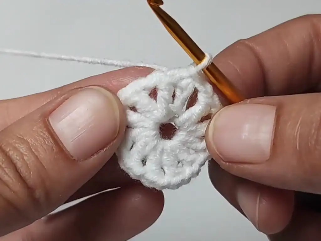 Completed white center of the crochet Christmas tree granny square, ready for the next color change.