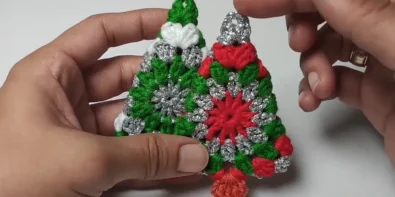 Two completed crochet Christmas tree ornaments, ready to hang.