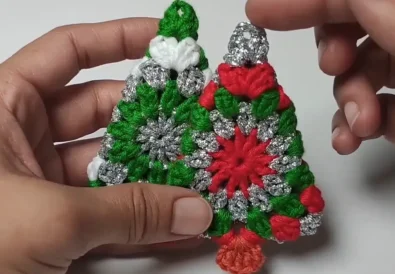 Two completed crochet Christmas tree ornaments, ready to hang.