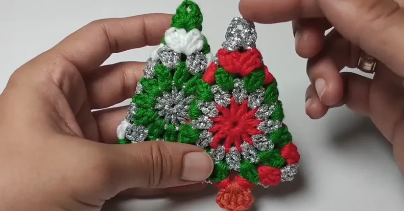 Two completed crochet Christmas tree ornaments, ready to hang.