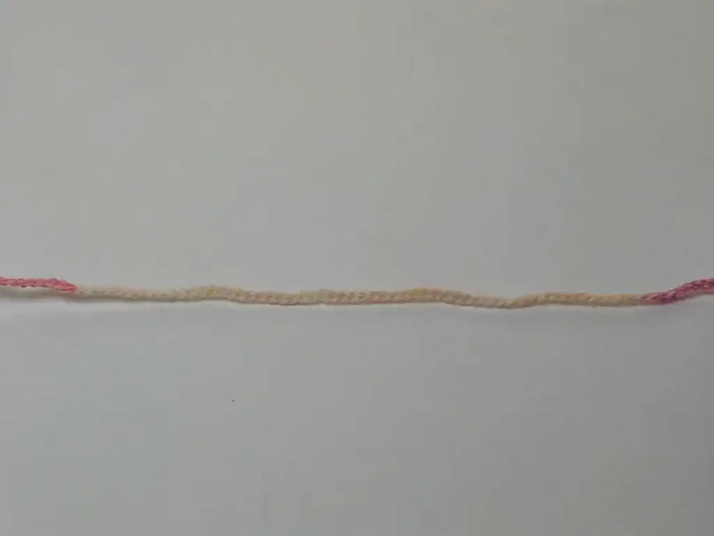 The first image shows a long foundation chain made with a variegated yarn, using pink and cream.